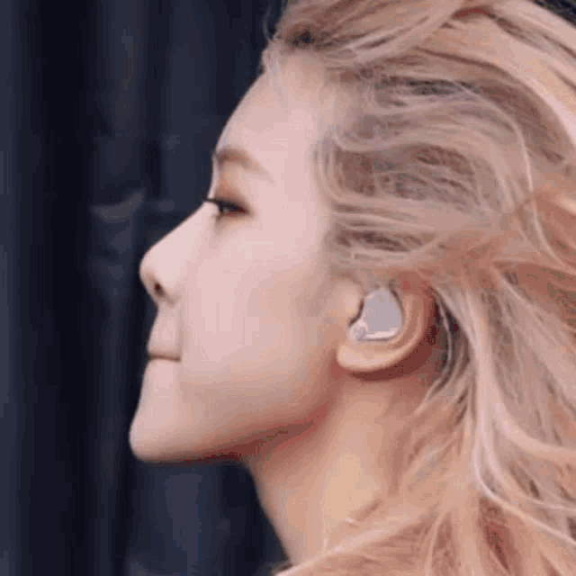 a close up of a woman 's face wearing a pair of headphones .