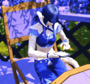 a woman with blue hair is sitting in a chair looking at a tablet