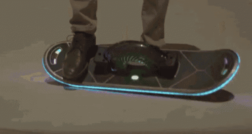 a group of people are riding skateboards that are lit up at night