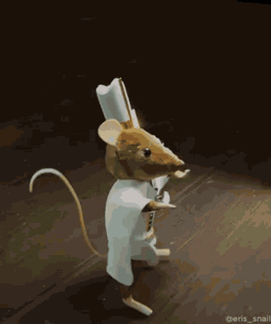 a mouse wearing a chef 's hat and gloves