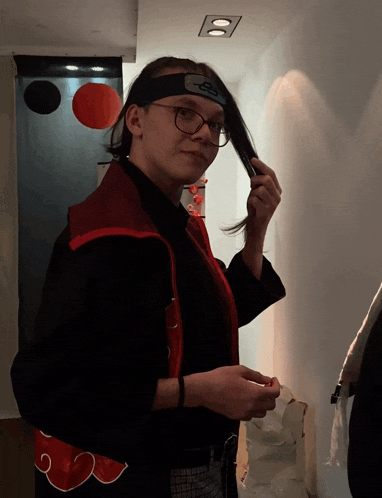 a woman wearing glasses and a headband with the letter s on it