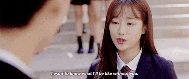 a girl in a school uniform is talking to a man in a suit .