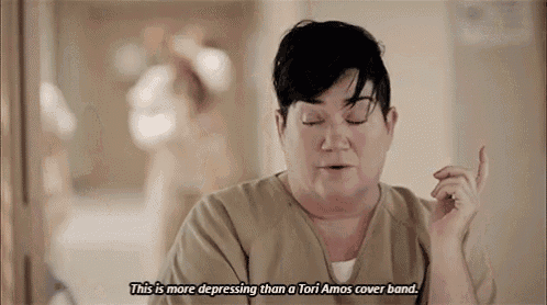 a woman is making a funny face and saying `` this is more depressing than a tori amos cover band ! ''