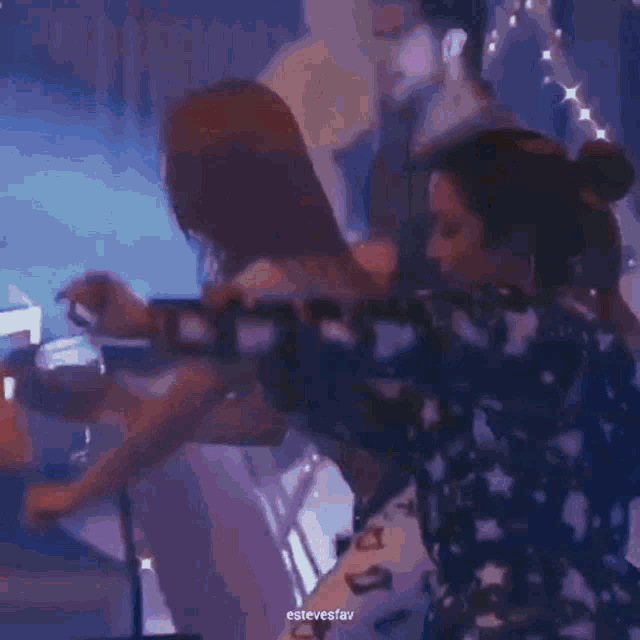 a blurry picture of a man and a woman in a dark room with a blue background