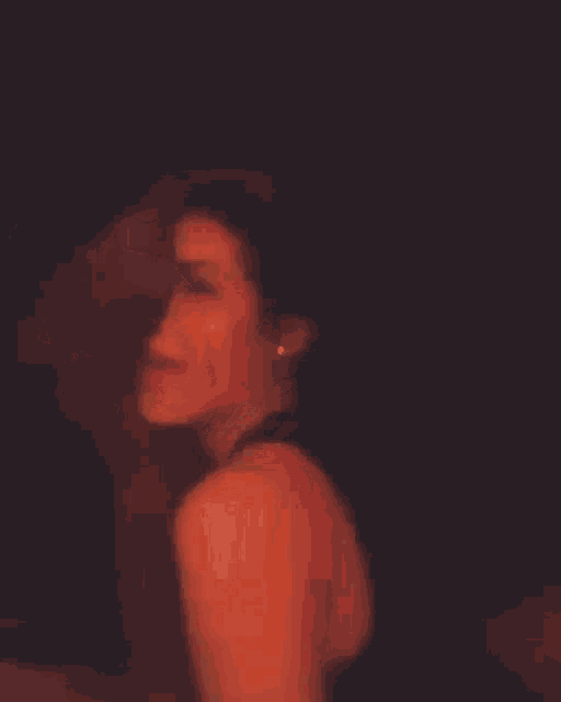 a woman in a black tank top is smiling with her hair in the foreground