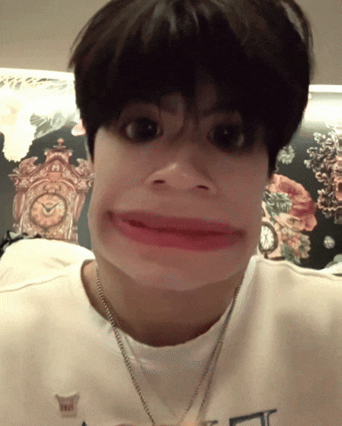 a person making a funny face with a clock behind them