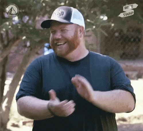 a man with a beard wearing a hat with the word wife swap on it