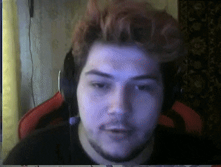 a man wearing headphones looks at the camera in a blurry photo
