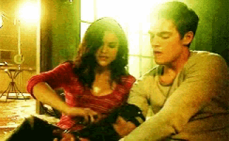 a man and a woman are sitting next to each other in a dark room
