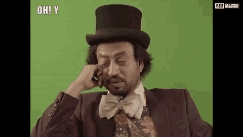 a man in a top hat and bow tie is crying .