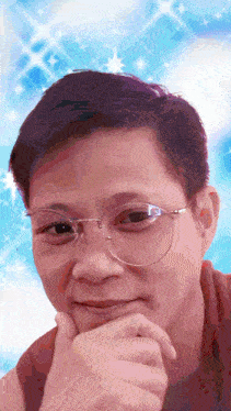 a man wearing glasses looks at the camera with a blue background