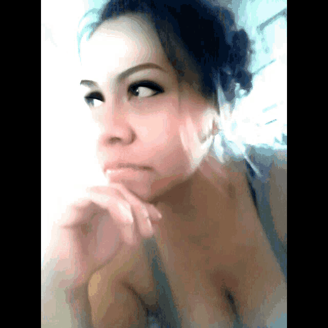 a close up of a woman 's face with a blurred background