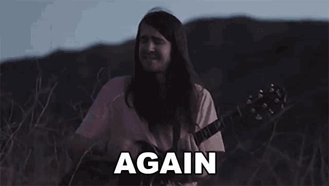 a man with long hair is singing and playing a guitar with the words again above him