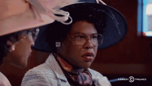a woman wearing a hat and glasses is sitting next to another woman wearing a hat and glasses .