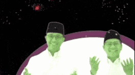 a couple of men are standing next to each other in front of a purple and black background .