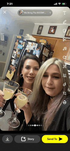a phone screen shows two women toasting with champagne glasses and the time is 7:31