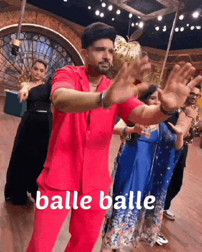 a man in a red suit is holding a ball and the word balle balle is on the bottom