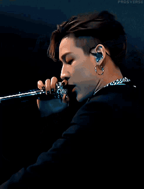 a close up of a person singing into a microphone with the word prodsverse visible
