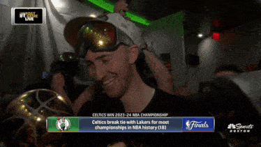 a man holding a trophy with the words celtics win 2023-24 nba championship on the bottom