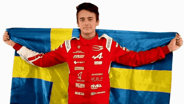 a man in a red jacket with the letter a on it holds a swedish flag