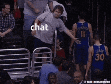 a man in a gray shirt with the word chat on the back