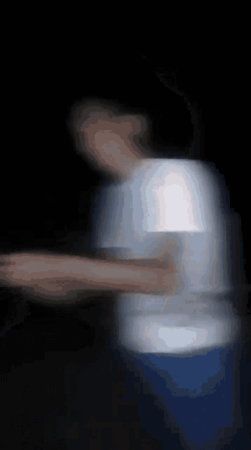 a blurred image of a person 's face with a dark background