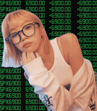 a woman wearing glasses is standing in front of a screen that says spx69000