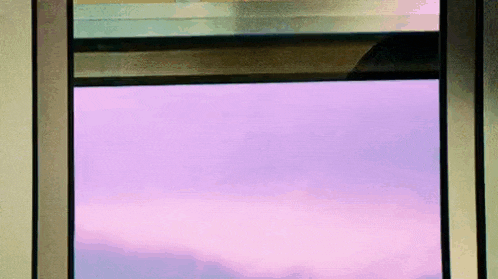 a window with a purple sky outside of it