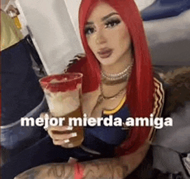 a woman with red hair is holding a cup of beer and a drink .