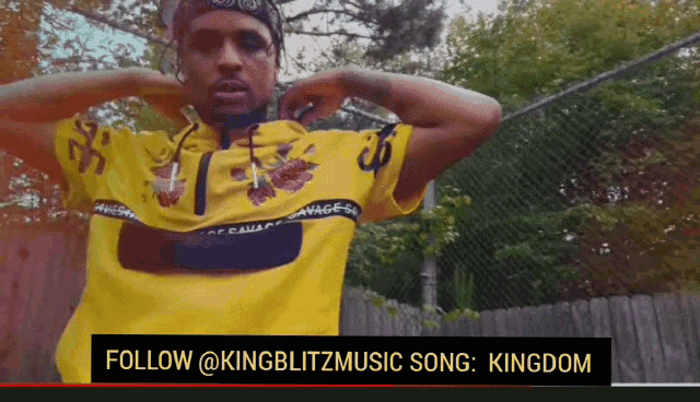 a man wearing a yellow shirt with the words follow @kingblitzmusic song kingdom on the bottom