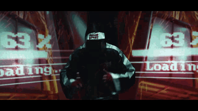 a man wearing a hat that says never trust stands in front of a screen that says loading