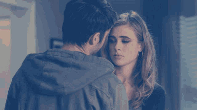 a man and a woman are looking at each other with their eyes closed