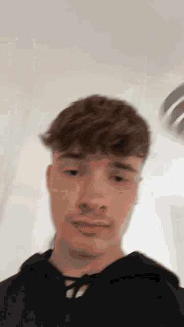 a close up of a young man 's face with a blurred background .