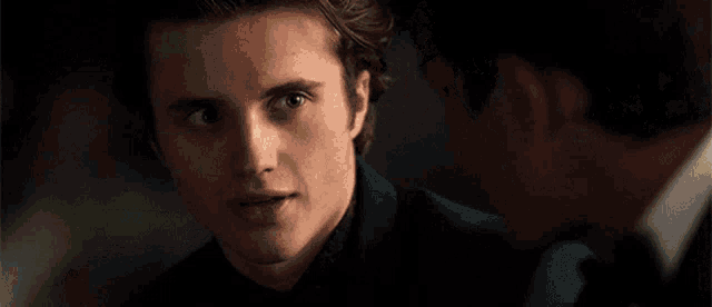 a man in a suit is talking to another man in a suit .