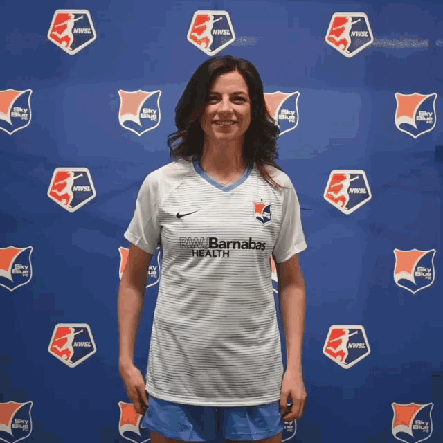 a woman wearing a white shirt with rw barnabas health on it