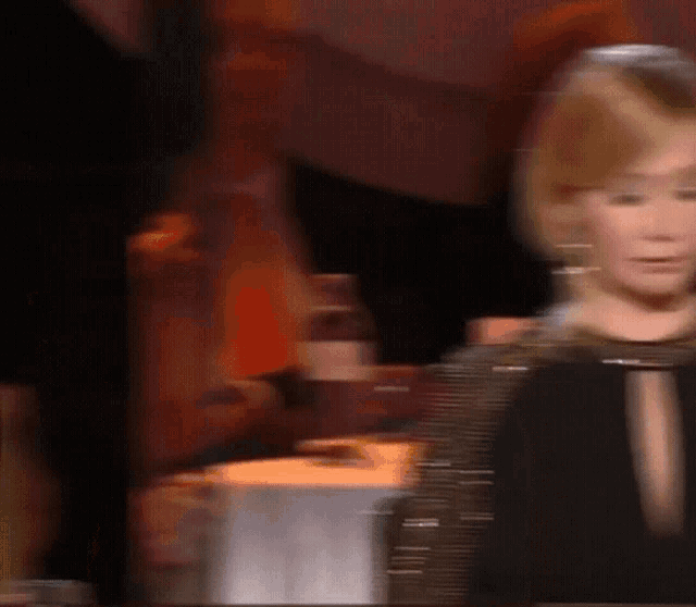 a blurry picture of a woman 's face in a dark room