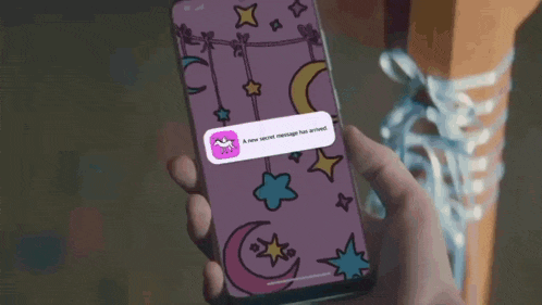 a person is holding a cell phone with a message on the screen that says a new secret message has arrived