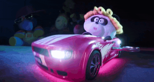 a stuffed animal is driving a pink sports car