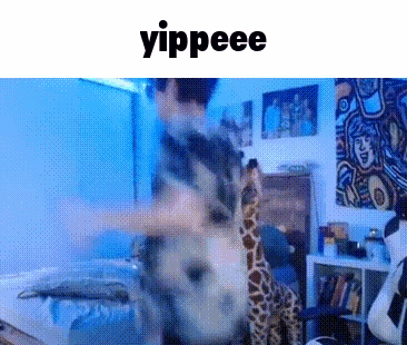 a man is holding a stuffed giraffe in a room with the word yippeee above him