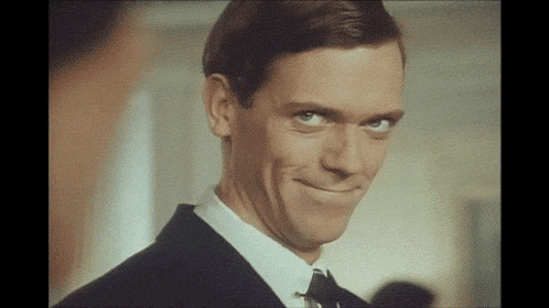 a man in a suit and tie is smiling