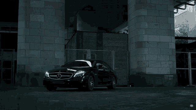 a black car is driving under a bridge with a sign that says limna group