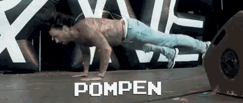 a shirtless man is doing push ups in front of a sign that says " pompen "