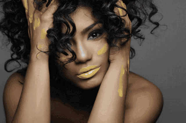 a woman with curly hair and yellow lipstick on her face