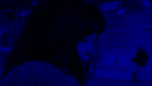 a woman 's face is shown in a blue background