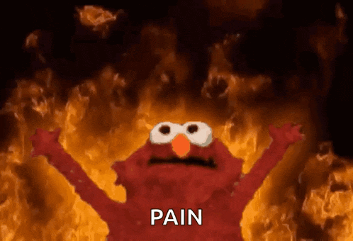 elmo from sesame street is standing in front of a fire with the word pain written on it .