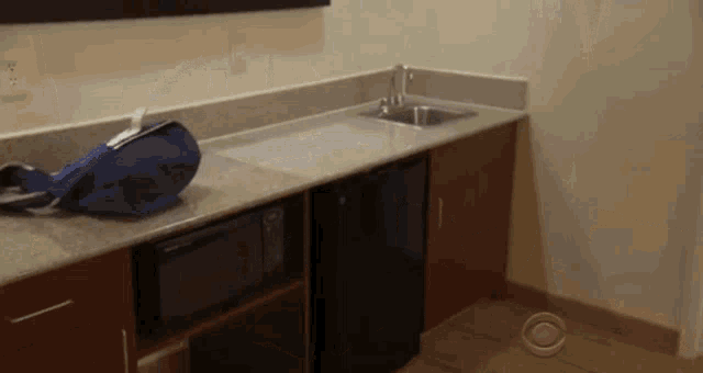 a small kitchen with a microwave and a sink