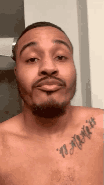 a man without a shirt has a tattoo on his chest that reads " i might it "