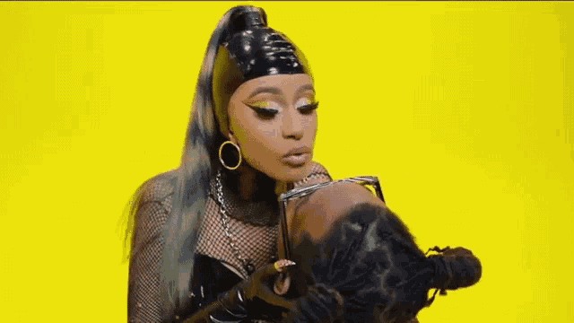 a woman is kissing a man on the cheek while wearing a black headband .