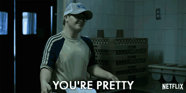 a man in a hat says you 're pretty in a kitchen