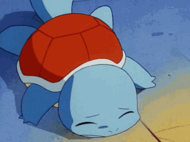 a cartoon turtle with a red shell laying on its back